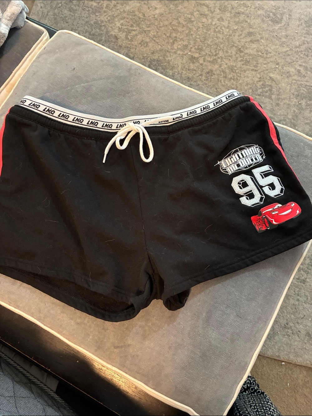 Black Athletic Women's Shorts with Red Trim and Graphic Detail